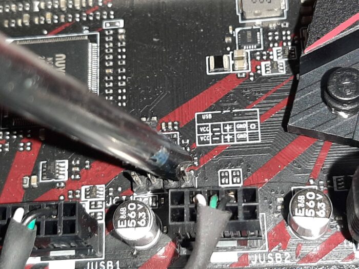 Short motherboard pins to reset BIOS to default settings